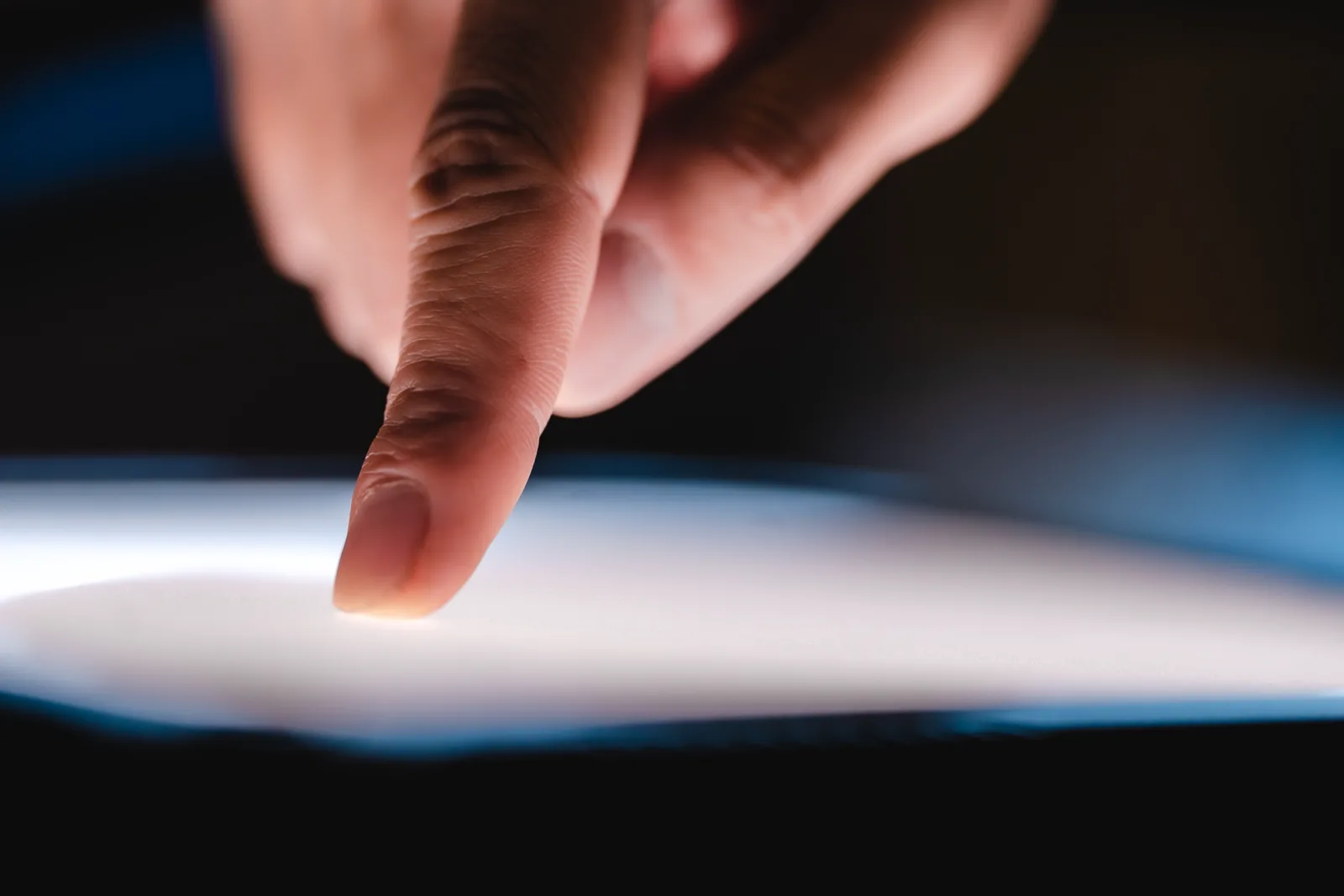 A hand endlessly scrolling a phone feed, the screen a blur of content